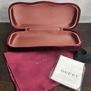 Dark red Gucci sunglasses case with dust over and lens cloth